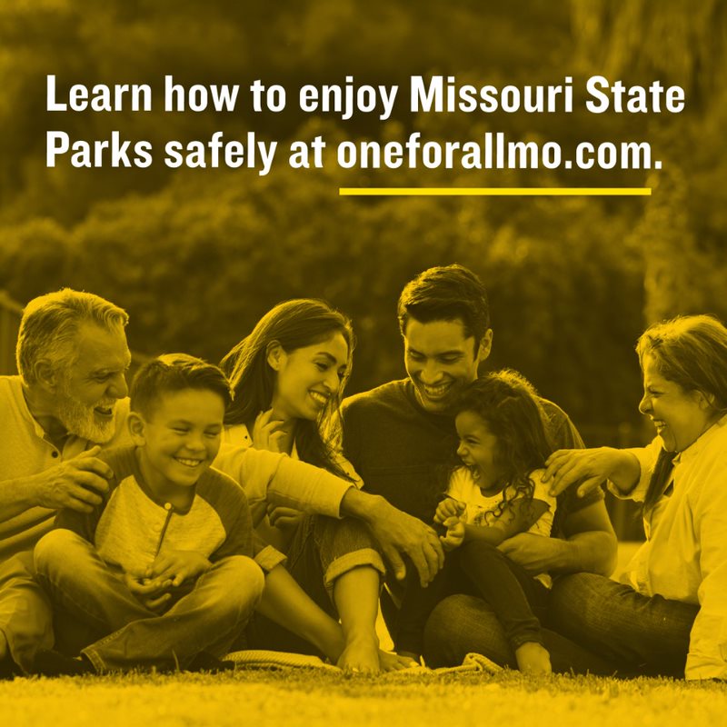 Background image of extended family laughing and sitting in grass with overlay text that states Learn how to enjoy Missouri State Parks safely at oneforallmo.com.