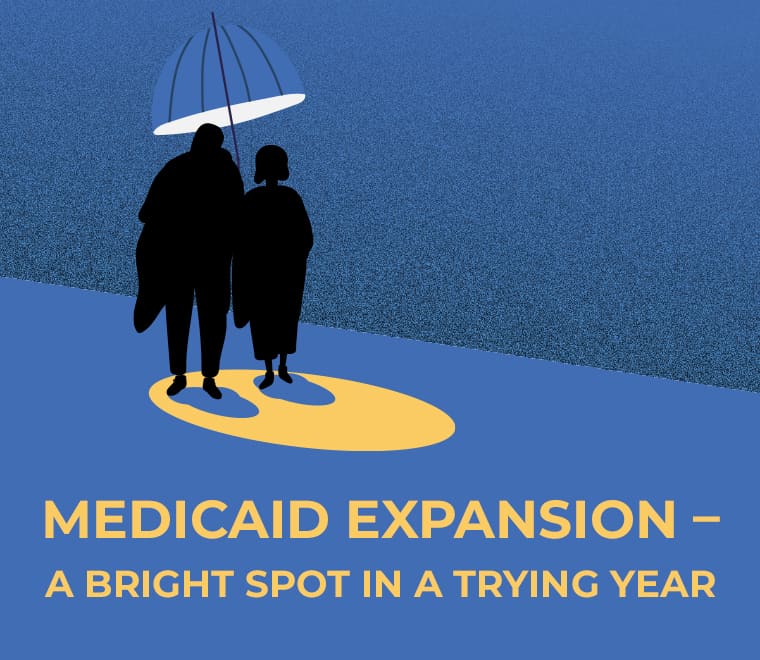 Medicaid expansion a bright spot in a trying year illustration with a silouhette of a couple under an umbrella in a spotlight.