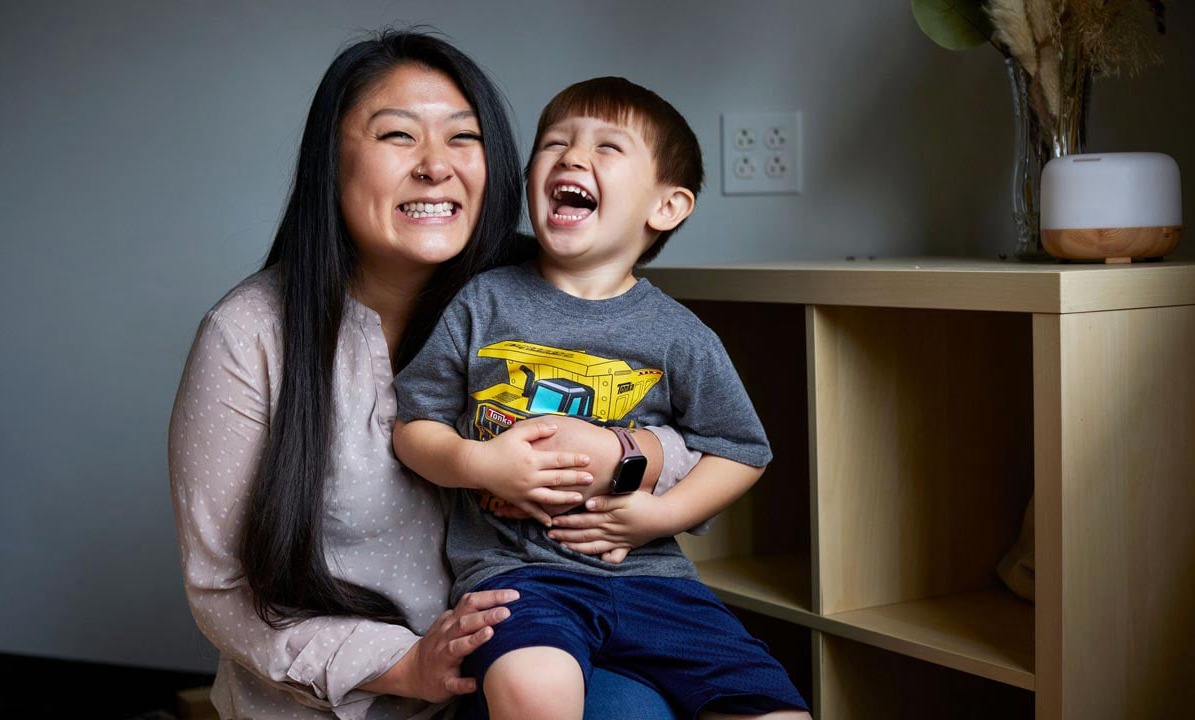 New MFH iconic photo of smiling Asian woman and child seated indoors
