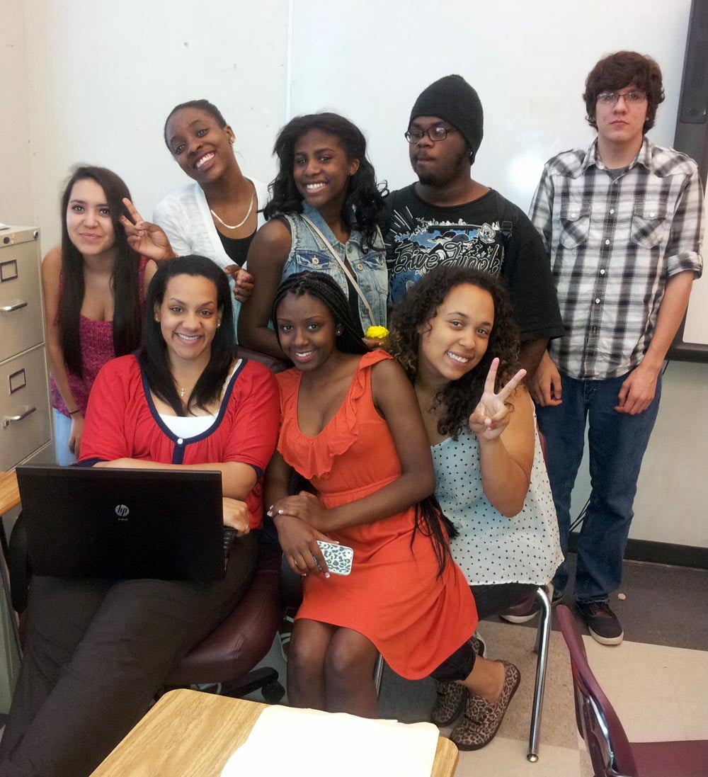 Photo of Ivory posing with a group of students