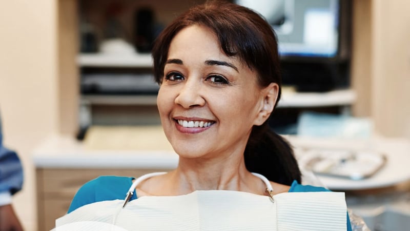Middle aged woman smiling at dentist office