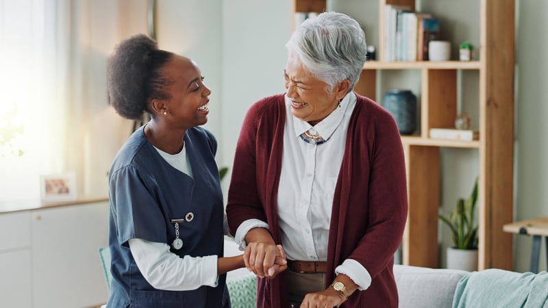 medical professional assisting smiling senior woman