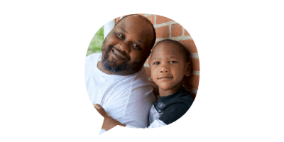 Speech bubble with image of man and child smiling in front of brick home