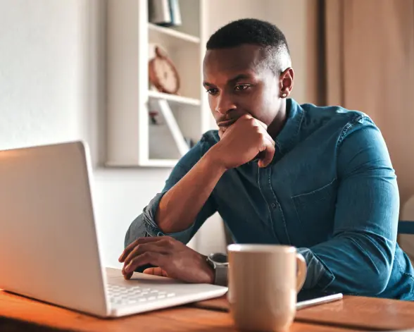 Yong man is working on a laptop