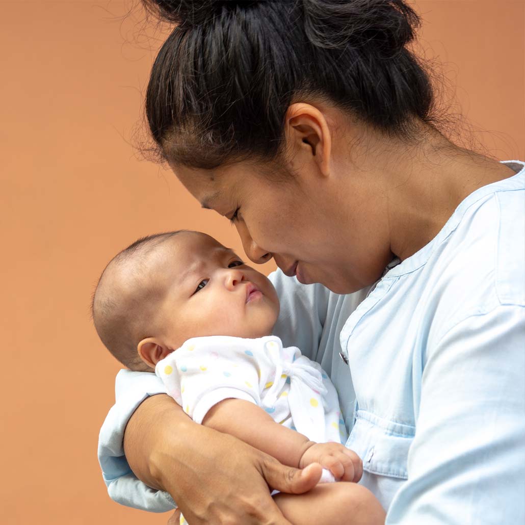 Photo of a mother holding young infant