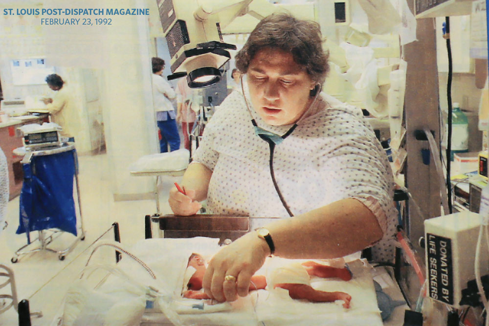 Photo taken from St. Louis Post-Dispatch magazine showing Dr. Corinne Walentik treating a baby in pediatric ward, February 23, 1992