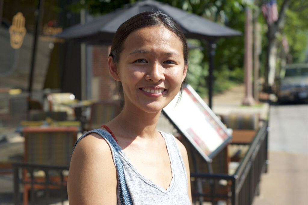 Woman smiling outside of a restaurant