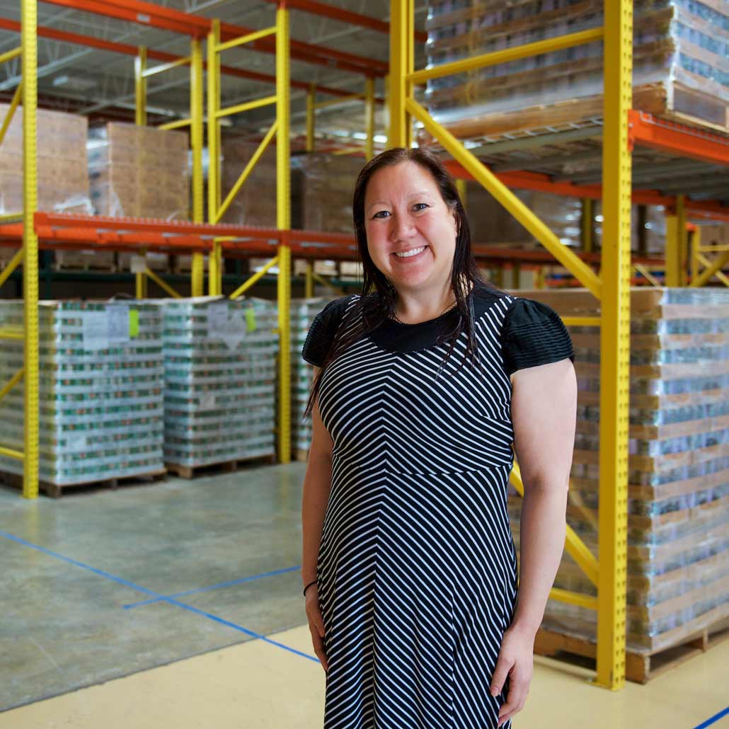 Woman standing in stock room of food pantry facility