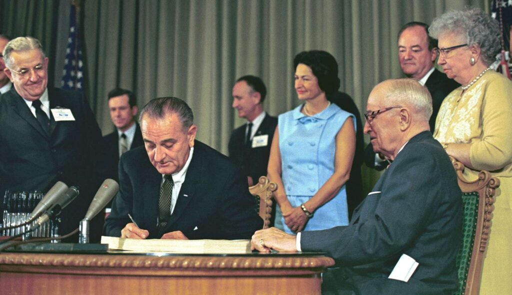 Johnson and LBJ sign Medcaid into law