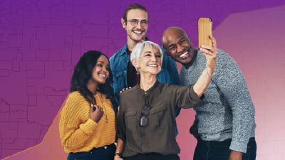 Group of people taking a selfie in frot of Purple gradient background with hint of linegraph elements